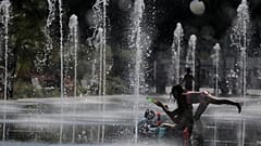  People cool off in a fountain in Nice during a heatwave that has enveloped much of France, June 27, 2019