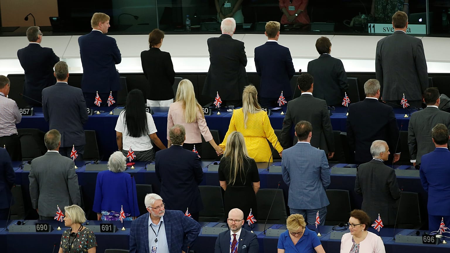 Members of the Brexit Party turn their back to the assembly as the European anthem is played, during the first plenary session of the newly elected European Parliament.