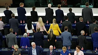 Members of the Brexit Party turn their back to the assembly as the European anthem is played, during the first plenary session of the newly elected European Parliament.