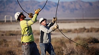FILE PHOTO: Linemen repair lines that were broken during a powerful earthquake that struck Southern California, July 4, 2019.