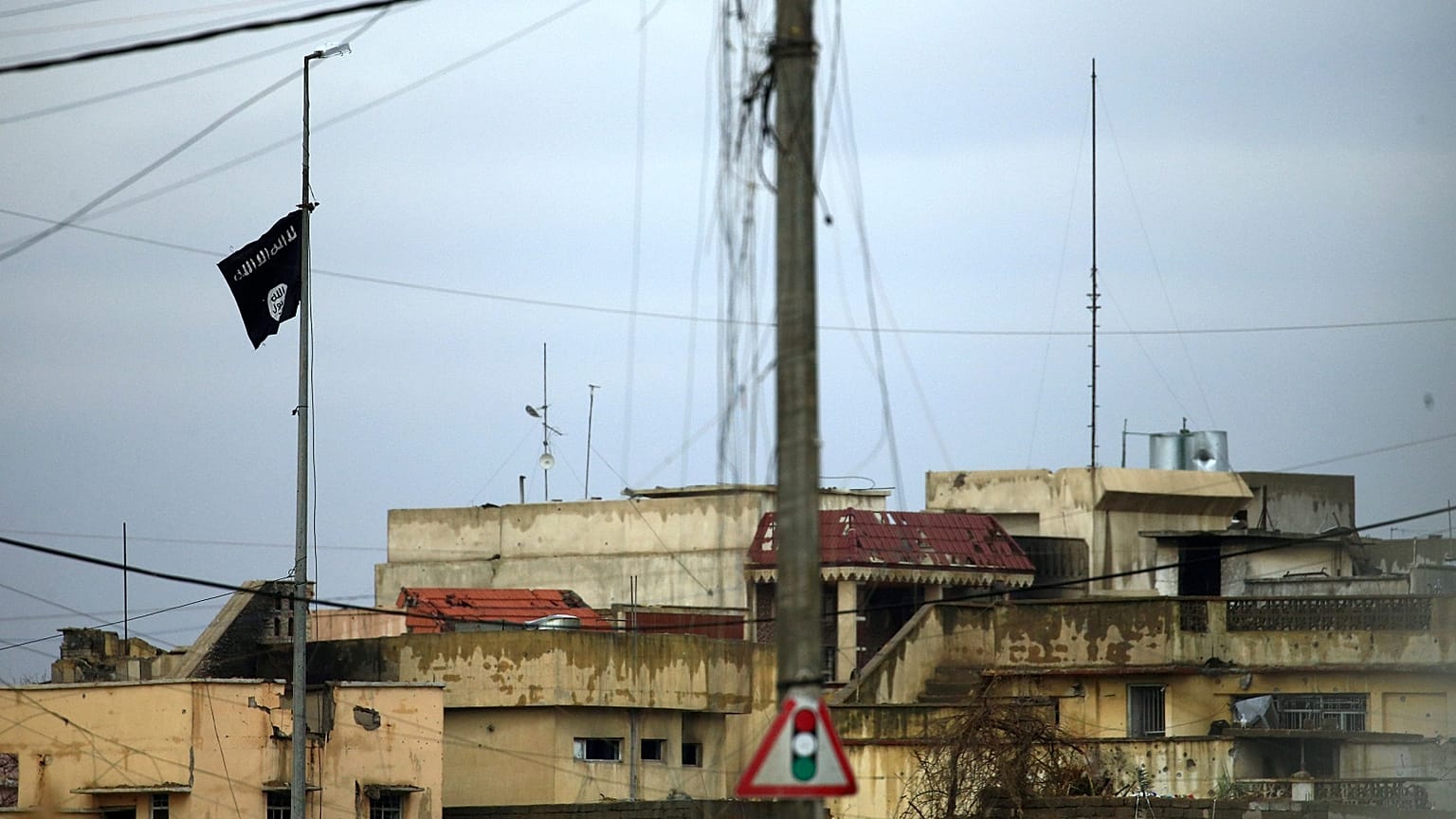 An IS flies in an area of Mosul where fighters are clashing with Iraqi forces.