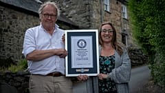 Gwyn Headley and Sarah Badham hold a certificate for the record title for world's steepest street, in Harlech, Wales, Britain July 10, 2019.