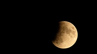 The moon is seen during a partial lunar eclipse in Venice, Italy July 16, 2019. 