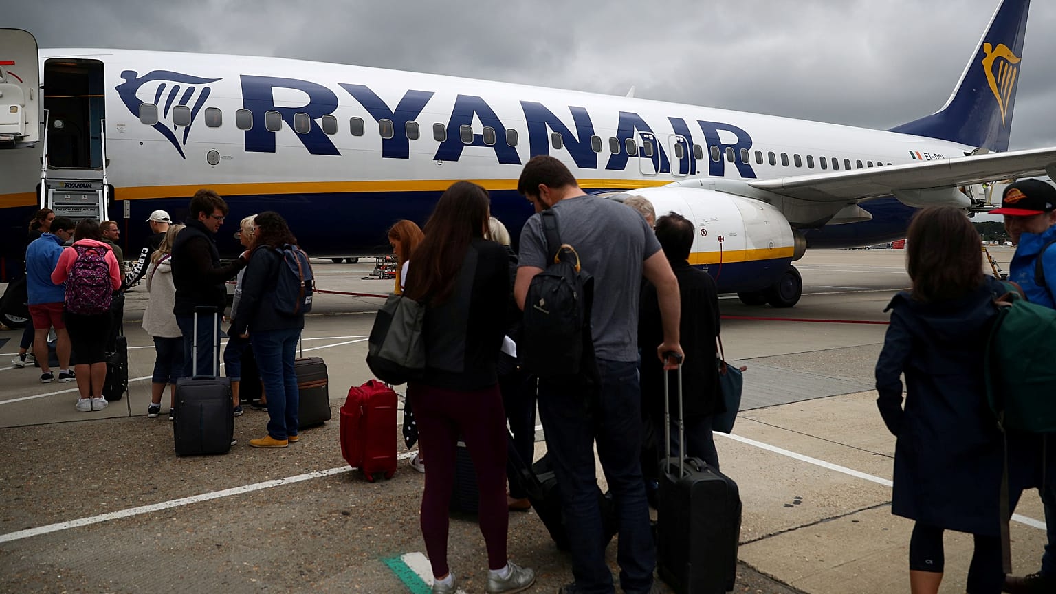 FILE PHOTO: Passengers wait to board a Ryanair flight at Gatwick Airport in London, Britain