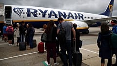 FILE PHOTO: Passengers wait to board a Ryanair flight at Gatwick Airport in London, Britain