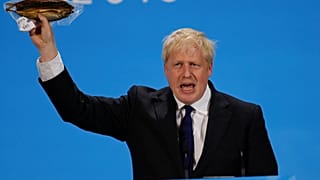 Boris Johnson holds a plastic wrapped kipper fish during a hustings event in London, Britain July 17, 2019