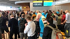 Passengers and staff wait at Amsterdam Schiphol airport during an outage at the airport's main fuel supplier that kept dozens of flights on the ground, 