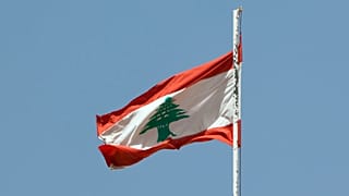 The lebanese flag floating over the palace of Beiteddine.