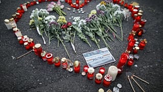 Flowers and candles are left by people during an anti-government demonstration in Bucharest, Romania, July 27, 2019. 