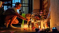 A mourner lights a candle at a memorial during a vigil at the scene of a mass shooting in Dayton, Ohio, U.S. August 4, 2019.
