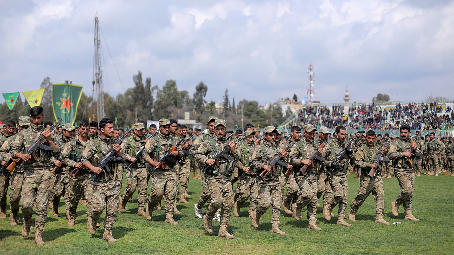 FILE PHOTO: Kurdish fighters from the People's Protection Units (YPG) take part in a military parade, in Qamishli, Syria, March 28, 2019. 