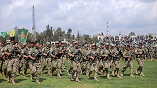 FILE PHOTO: Kurdish fighters from the People's Protection Units (YPG) take part in a military parade, in Qamishli, Syria, March 28, 2019.