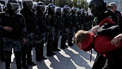 Law enforcement officers detain a participant in a rally calling for opposition candidates to be registered for elections to Moscow City Duma on August 3