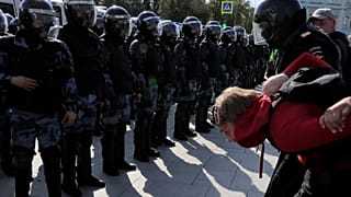 Law enforcement officers detain a participant in a rally calling for opposition candidates to be registered for elections to Moscow City Duma on August 3