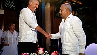 David Cutter and Juan Gonzalez Escalona shake hands after signing a joint venture to market Santiago de Cuba rum