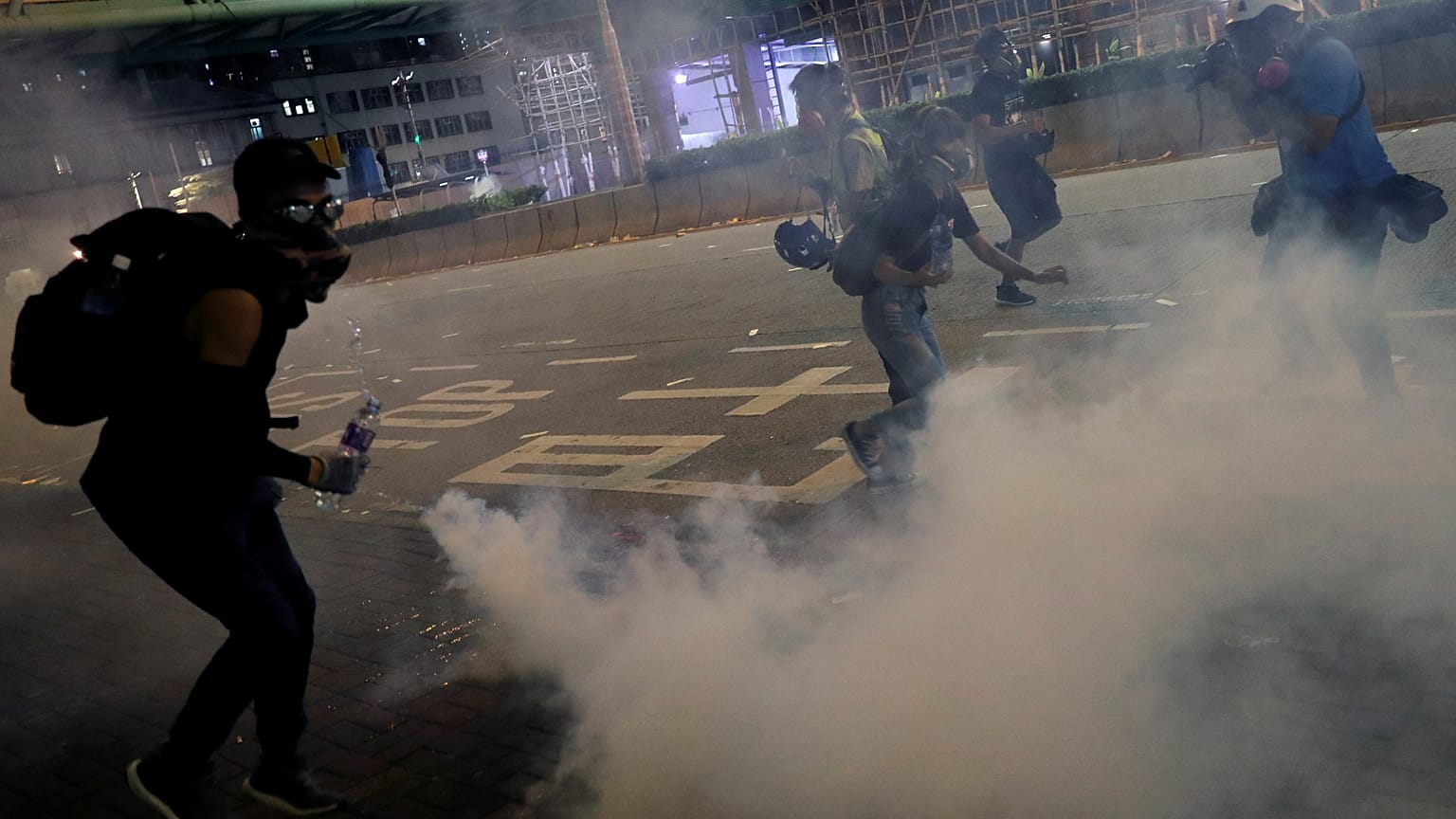 Anti-extradition bill protesters react after the police fired tear gas to disperse the demonstration at Sham Shui Po, in Hong Kong, China August 14, 2019. 