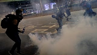 Anti-extradition bill protesters react after the police fired tear gas to disperse the demonstration at Sham Shui Po, in Hong Kong, China August 14, 2019. 