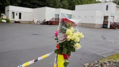 Flowers and a police tape are seem outside Al-Noor Islamic Centre Mosque, a day after a gunman's attack, in Baerum outside Oslo, Norway, 12 August, 2019.