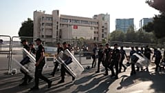 Turkish police walk in front of the Metropolitan Municipality headquarters in Diyarbakir, Turkey, August 19, 2019. 