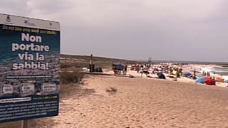 A sign warning people on a beach in Sardinia not to take the sand