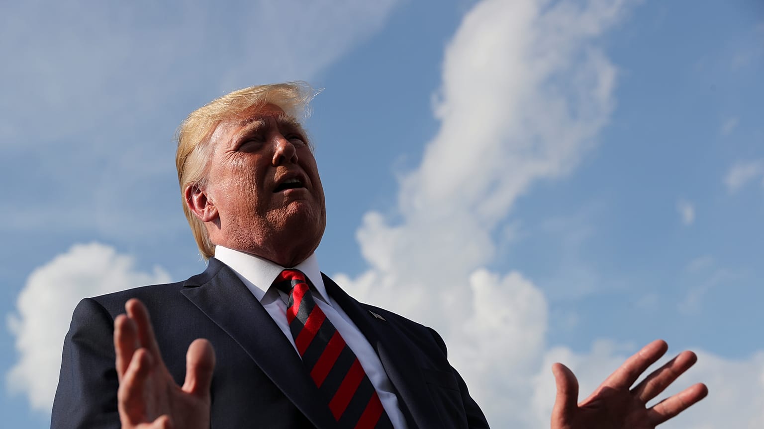 US President Donald Trump speaks to reporters before boarding Air Force One 