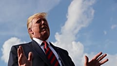 US President Donald Trump speaks to reporters before boarding Air Force One 