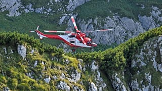 Mountain rescue team (TOPR) helicopter is pictured in Tatra mountains during a search mission to save two cavers trapped in a cavern near Zakopane, Poland August 19, 2019. 