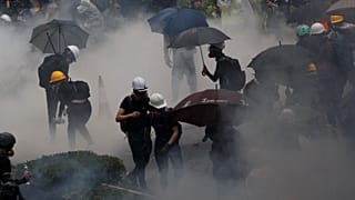 Anti-extradition bill protesters are surrounded by tear gas during clashes with police in Tsuen Wan in Hong Kong, China August 25, 2019. Picture taken August 25, 2019.