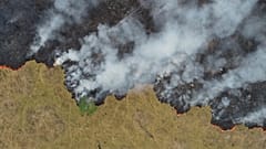 An aerial view shows smoke rising over a deforested plot of the Amazon jungle in Porto Velho, Rondonia State, Brazil, in this August 24, 2019 picture taken with a drone. 