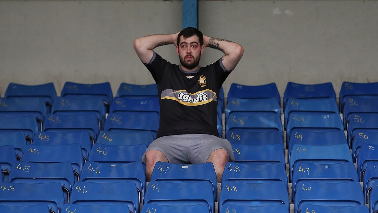 Bury fan, at their ground Gigg lane, after finding out their takeover deal fell through