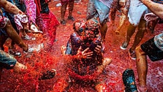 Watch live: Thousands hurl fruit at La Tomatina festival