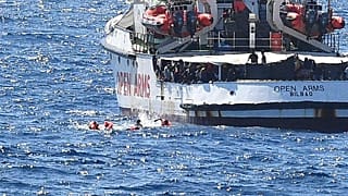 igrants jump off the Spanish rescue ship Open Arms, close to the Italian shore in Lampedusa