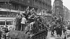 Belgian civilians cheer British troops in Brussels on September 4, 1944. 