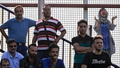 A female fan looks on as an Esteghlal FC game is underway