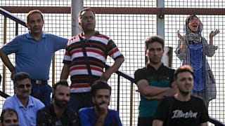 A female fan looks on as an Esteghlal FC game is underway