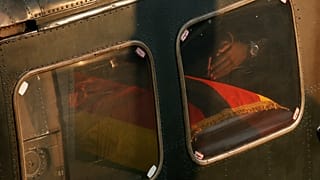Robert Mugabe Junior's hands are seen near a casket carrying the remains of his father, Robert Mugabe.