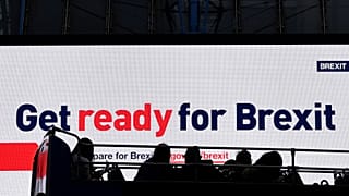 A bus passes an electronic billboard displaying a British government Brexit information awareness campaign advertisement in London, Britain