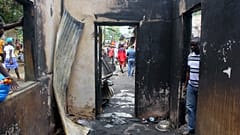 A man looks into a burned building after a fire swept through a school killing children in Monrovia