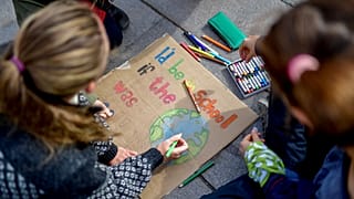 Young activists paint placards during the Fridays for Future global climate strike in Stockholm, Sweden, September 20, 2019.