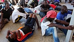Migrants are seen after being rescued by Libyan coast guard in Khoms in August