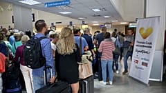 People line up in front of a counter of Thomas Cook at the Heraklion airport on the island of Crete, Greece September 23, 2019