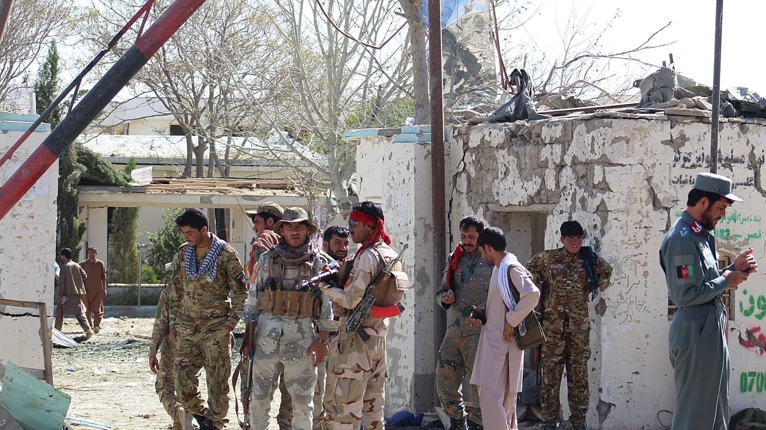 FILE PHOTO: Afghan security forces stand at the site of a car bomb attack in Qalat, capital of Zabul province, Afghanistan September 19, 2019. 