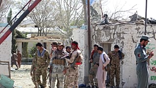 FILE PHOTO: Afghan security forces stand at the site of a car bomb attack in Qalat, capital of Zabul province, Afghanistan September 19, 2019.