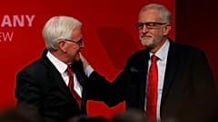 British Labour MP John McDonnell greets party leader Jeremy Corbyn on stage during the Labour party annual conference in Brighton, Britain September 23, 2019. 