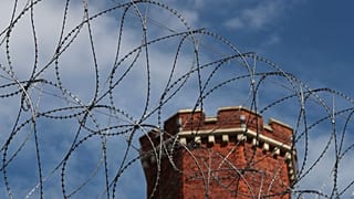 A general view shows razor wire surrounding the former Reading prison where Oscar Wilde was gaoled for gross indecency with another man, in Reading, Britain September 1, 2016.