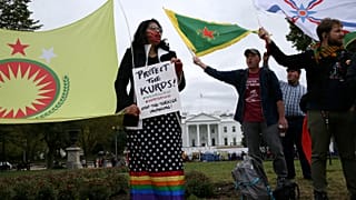 People rally to protest U.S. President Donald Trump's decision to withdraw U.S. troops from northeastern Syria in front of the White House
