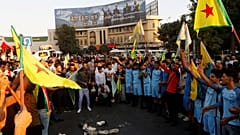 Kurds protest the Turkish offensive against Syria during a demonstration in Iraq