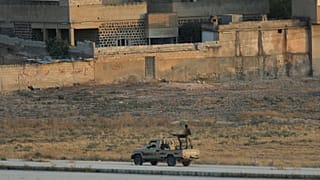 Turkish-backed Syrian rebels are seen in the Syrian border town of Tel Abyad, as seen from Akcakale, Turkey, October 13, 2019.