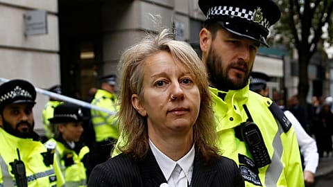 Extinction Rebellion co-founder arrested after smashing ministry window
