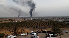 Smoke rises over the Syrian town of Ras al Ain, as seen from the Turkish border town of Ceylanpinar, in Sanliurfa province, Turkey, October 16, 2019.